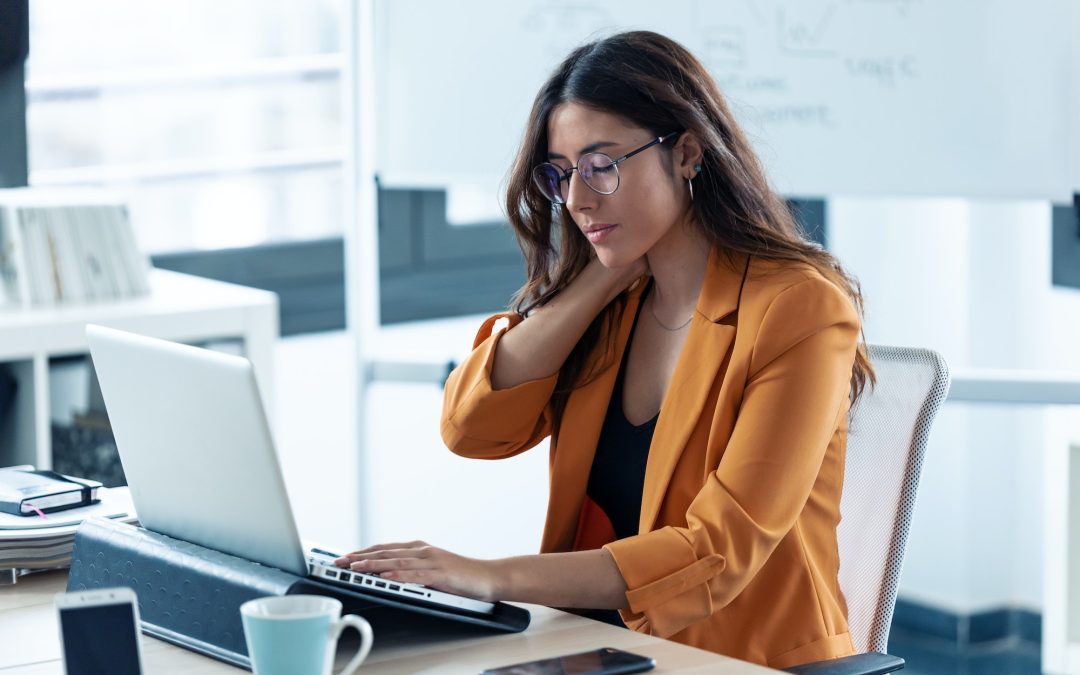 Business young woman with neck pain working with laptop in the office.