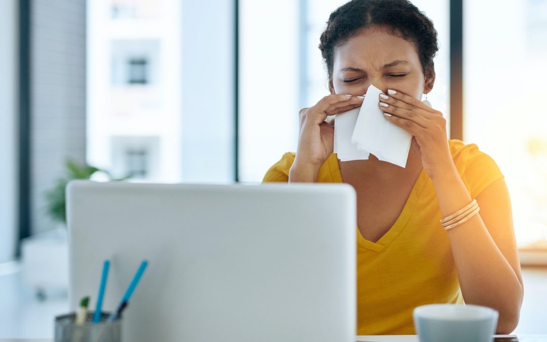 Her immune system could use a boost. Shot of a young designer blowing her nose in an office.