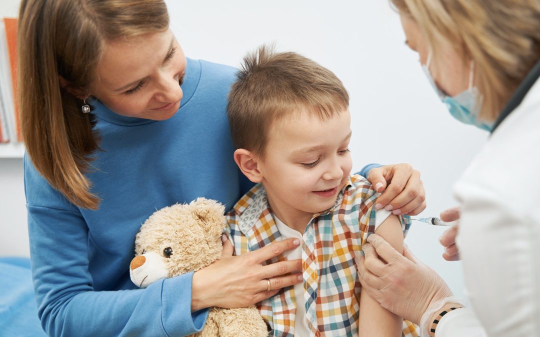 Smiling child receiving vaccine injection in pediatric clinic