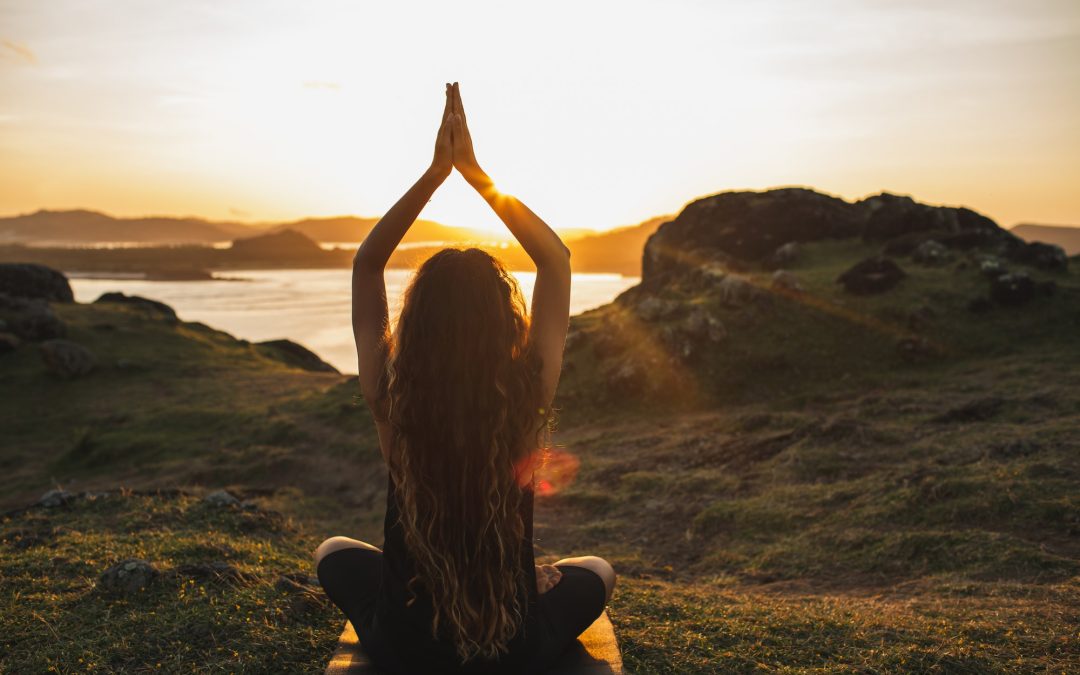 Young woman practicing yoga outdoors. Spiritual harmony, introspection and well-being concept