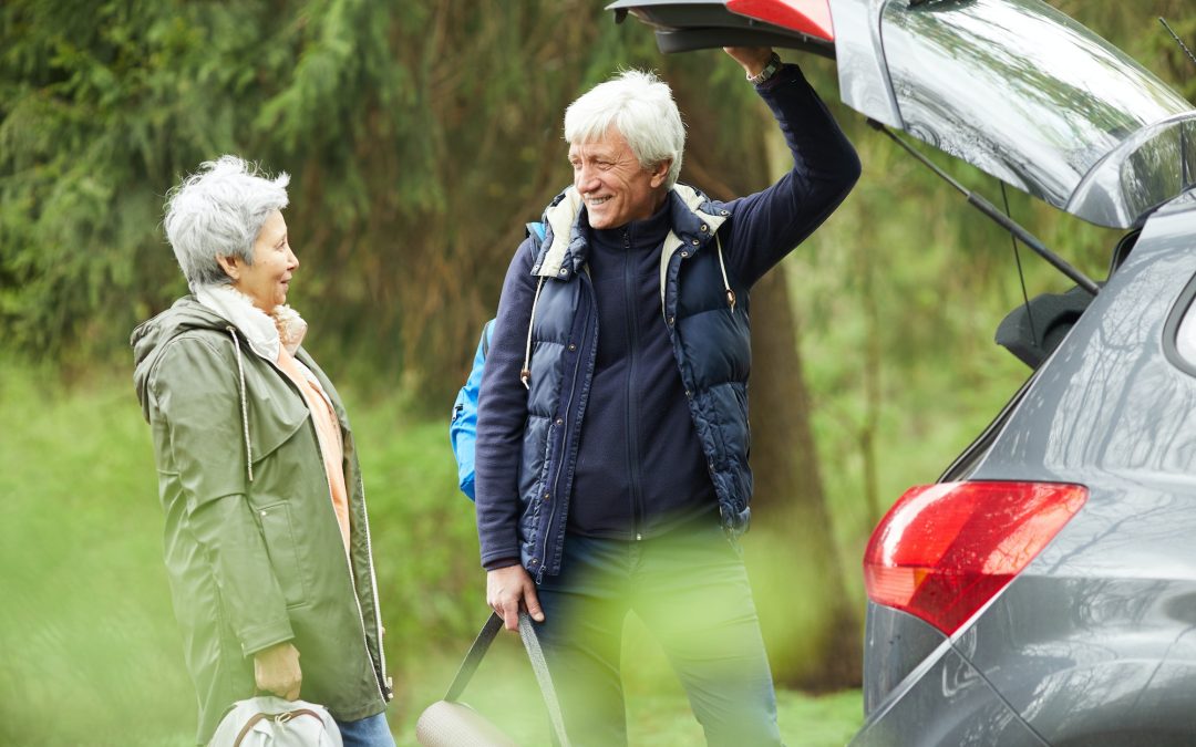 Active Senior Couple by Car