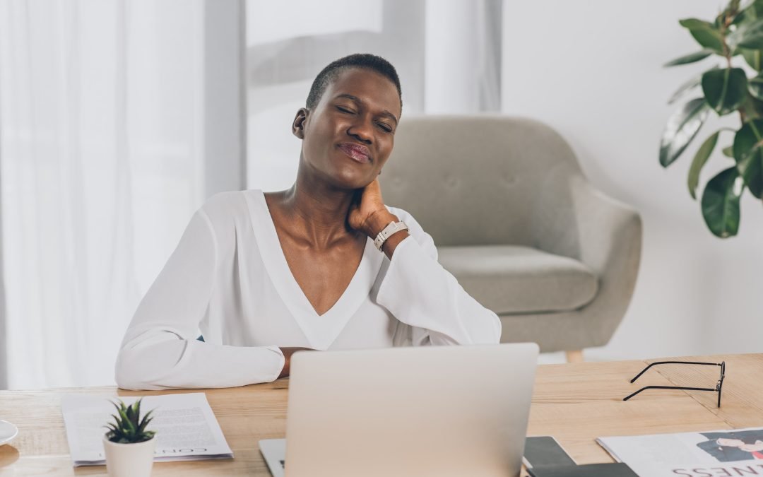exhausted stylish african american businesswoman touching painful neck in office