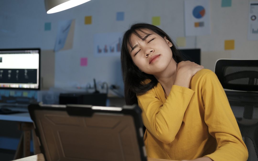 Young woman overtime work and feel shoulder and neck pain