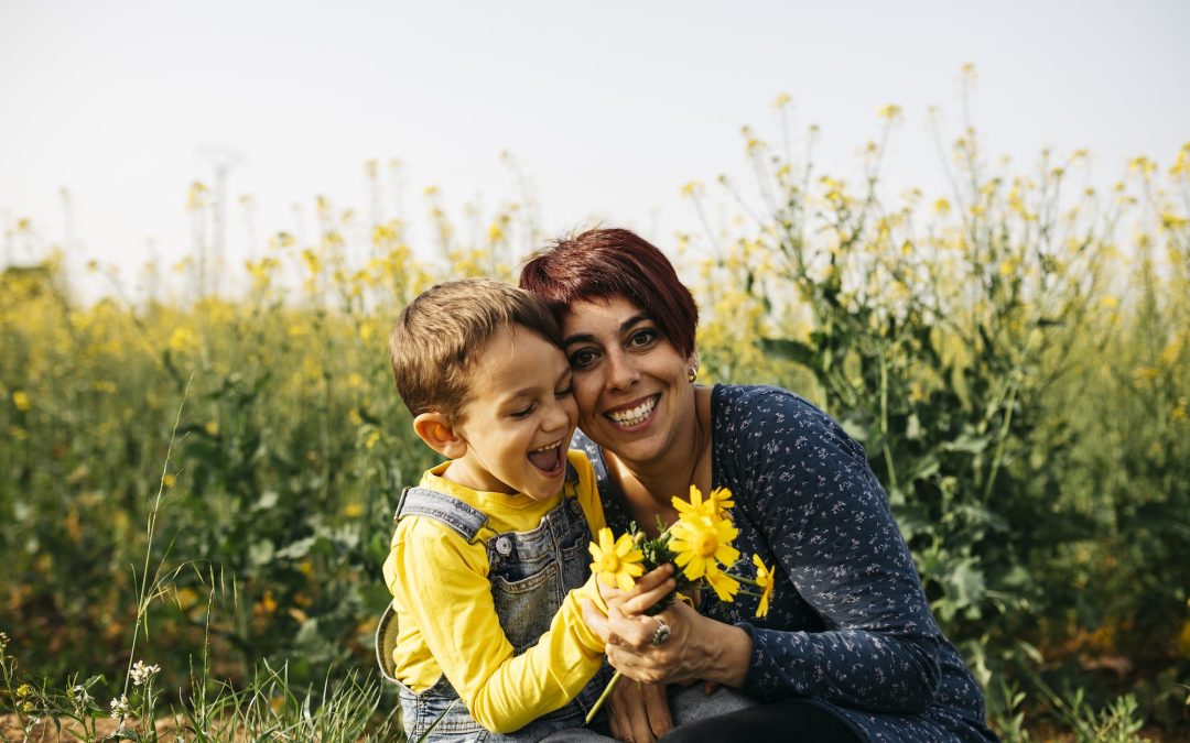Portrait of happy mother with little son in nature