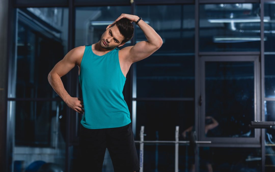 sportsman stretching neck in sports hall