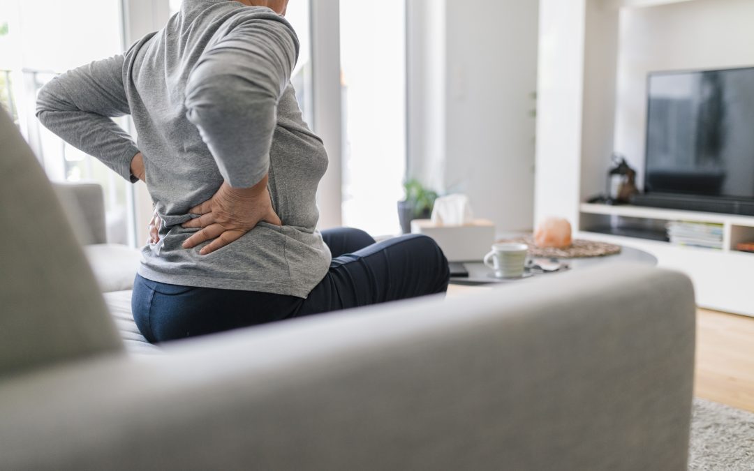 Elderly woman at home with back pain