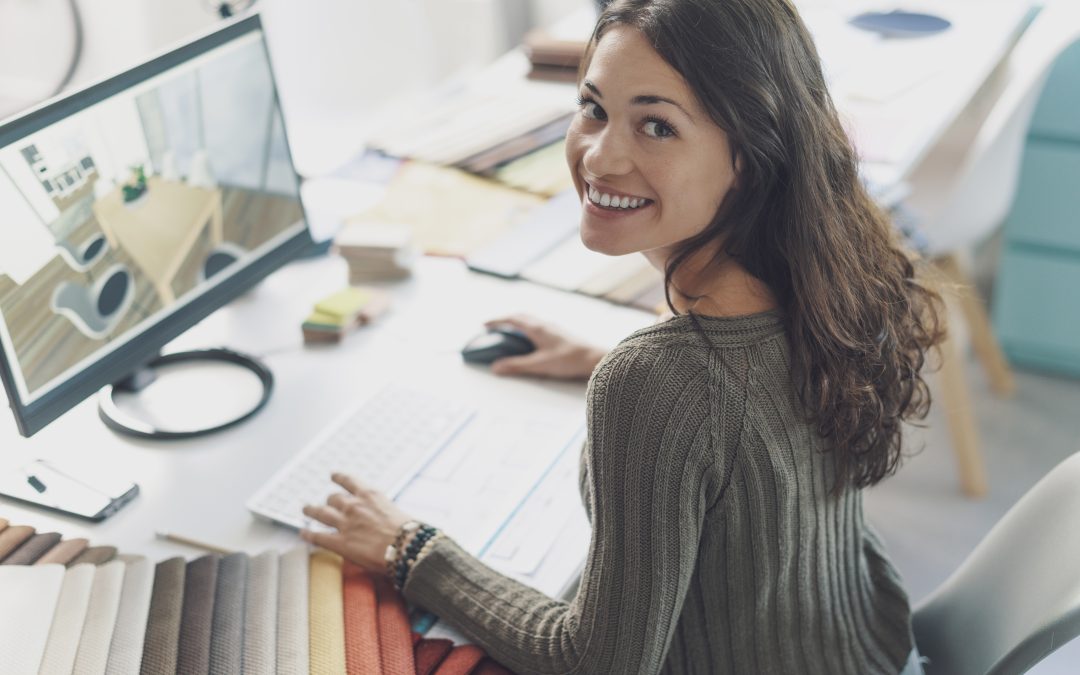 Smiling interior designer working at desk